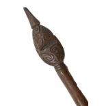 An early 20th century Maori staff with carved decoration to the flattened oval tip and with plain