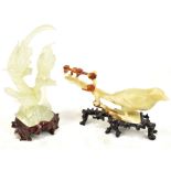 A Chinese polished hardstone group of three exotic birds mounted on a carved wooden stand, height