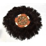 An African ostrich feather and leather circular panel.