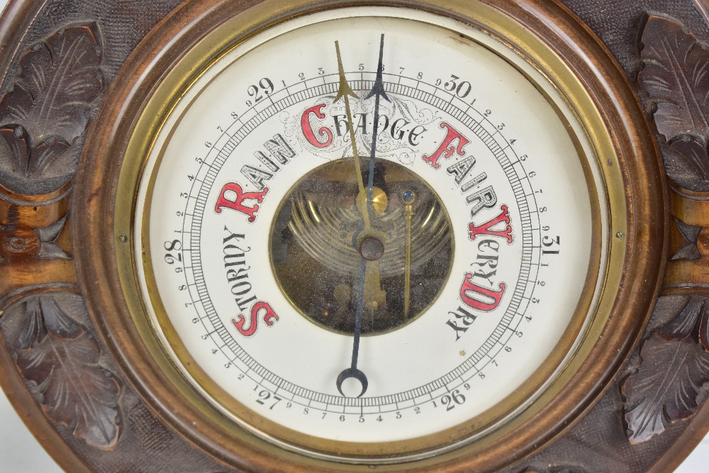A circa 1900 carved walnut and beech wheel barometer with relief carved detail and upper - Image 3 of 5