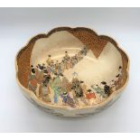 A Japanese Meiji period Satsuma bowl with shaped rim and interior decoration of a procession, the