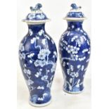 A pair of late 19th/early 20th century Chinese blue and white porcelain lidded vases decorated