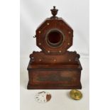 A 19th century rosewood mantel clock, the octagonal upper section enclosing enamelled dial set