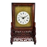 A circa 1900 Chinese rosewood cased mantel clock, the white enamel dial set with Roman numerals,