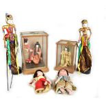 Five Japanese dolls, three fitted in wooden display cases, height of larger case 35cm, also two