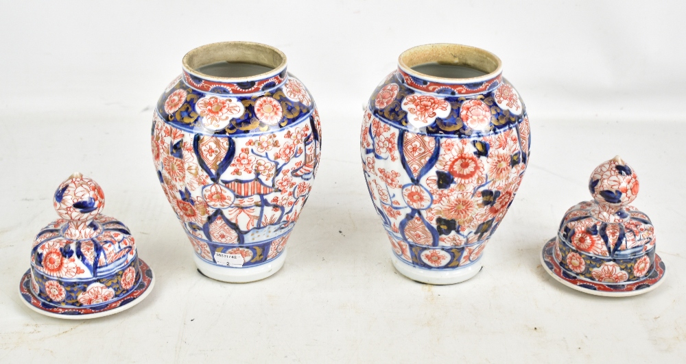 A pair of Japanese Meiji period Imari ribbed lidded vases with underglaze and gilt floral - Image 2 of 5
