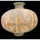 A Chinese Han dynasty earthenware cocoon vase with simple painted stylised detail on circular