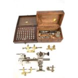 A group of clock manufacturer and repair tools and accessories including G.Boley lathe, clamps,