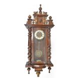 An early 20th century Vienna style wall clock in mahogany case, the circular dial with Roman