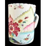 An 18th century Chinese porcelain Famille Rose mug, painted in enamels with floral decoration,