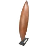 An Australian mulga wood parrying shield carved from a single piece, length 63cm, mounted on a