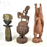 An African tribal wooden bowl and cover with figural surmount, a rustic carving and a metal and
