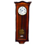 A late 19th century walnut and stained beech Vienna style wall clock with two piece white