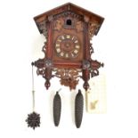 An early 20th century Black Forest cuckoo clock, the circular dial set with Roman numerals, height