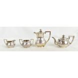 HUNG CHANG; a Chinese silver three piece tea service with panelled decoration and planished body,