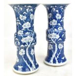 A pair of late 19th/early 20th century Chinese blue and white Gu vases, each painted with prunus