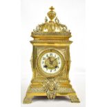 A late 19th century French brass cased mantel clock, the circular porcelain dial painted with Arabic