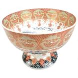 A Japanese Meiji period Imari bowl, the centre painted with landscape in underglaze blue, the
