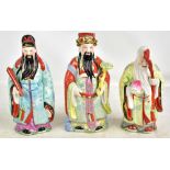 Three Chinese porcelain figures depicting the three gods 'Feng Shui, Fuk Luk, Sau Statu', each