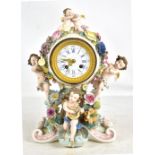 A late 19th century Continental porcelain floral encrusted mantel clock, the circular enamelled dial