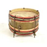 An early 20th century brass and wooden painted circular drum with red, white and blue upper and