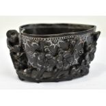 A 20th century Chinese carved black soapstone brush washer featuring monkey, flowering prunus and