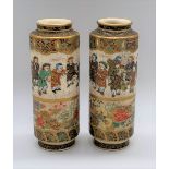 A pair of Japanese Meiji period Satsuma cylindrical vases each decorated with a band of children