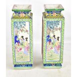 A pair of 20th century Chinese porcelain square section vases, each featuring enamelled panels of