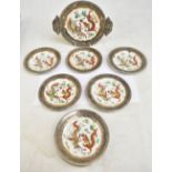 An Oriental porcelain part dinner set decorated in gilt and enamels with dragons chasing the