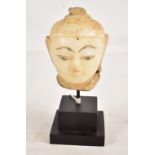 An 18th century Burmese carved alabaster fragmentary bust of the Buddha or a Bodhisattva, height