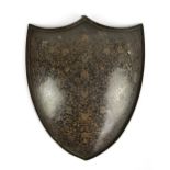 An early 20th century Indian lacquered copper decorative wall hanging plaque modelled as a shield,