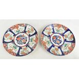 A pair of Japanese Meiji period Imari porcelain circular chargers painted with panels of birds and