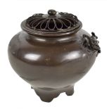 A Japanese Meiji period bronze incense burner and cover, decorated in relief with a single frog,