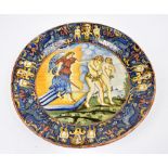 A 17th century Italian maiolica charger painted with a scene depicting an angel with sword barring
