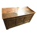 An 18th century Jacobean style oak coffer with carved and panelled detail to the front, height 68cm,