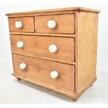 A late 19th/early 20th century miniature pine chest of two short over two long drawers with