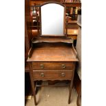 An early 20th century oak dressing table with domed swing mirror and two short drawers to