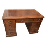 A late 19th century mahogany twin pedestal desk with brown leather inset top above an arrangement of