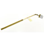 A 19th century brass extendable toasting fork, with swivel top, overall length 67cm.Additional