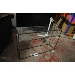 A contemporary rectangular wrought iron hall or console table with glass top above simple open