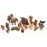 Fifteen 19th century and later carved treen models of dogs, to include Saint Bernard examples,