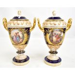 HELENA WOLFSOHN FOR DRESDEN; a pair of fine twin handled lidded pedestal urn vases, each with