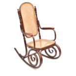 A late 19th/early 20th century bentwood rocking chair with canework back and seat panels.