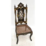 A Victorian black lacquered bedroom chair with painted, gilt and inlaid mother of pearl detail, cane