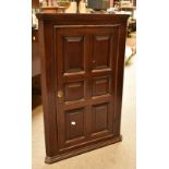 A 19th century oak flat fronted corner cupboard with single panelled door, height 87cm, width