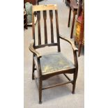 WYLIE & LOCHHEAD; an Arts & Crafts oak elbow chair on stretchered supports for restoration,
