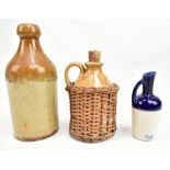 A stoneware bottle stamped 'T.Bayley Congleton' height 16.8cm, and two smaller jugs, one in rattan