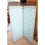 An early 20th century Eastern style two panel folding screen with carved detail to the cornice and