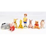 BESWICK; a set of Winnie the Pooh figurines, printed factory marks to base (8).Additional