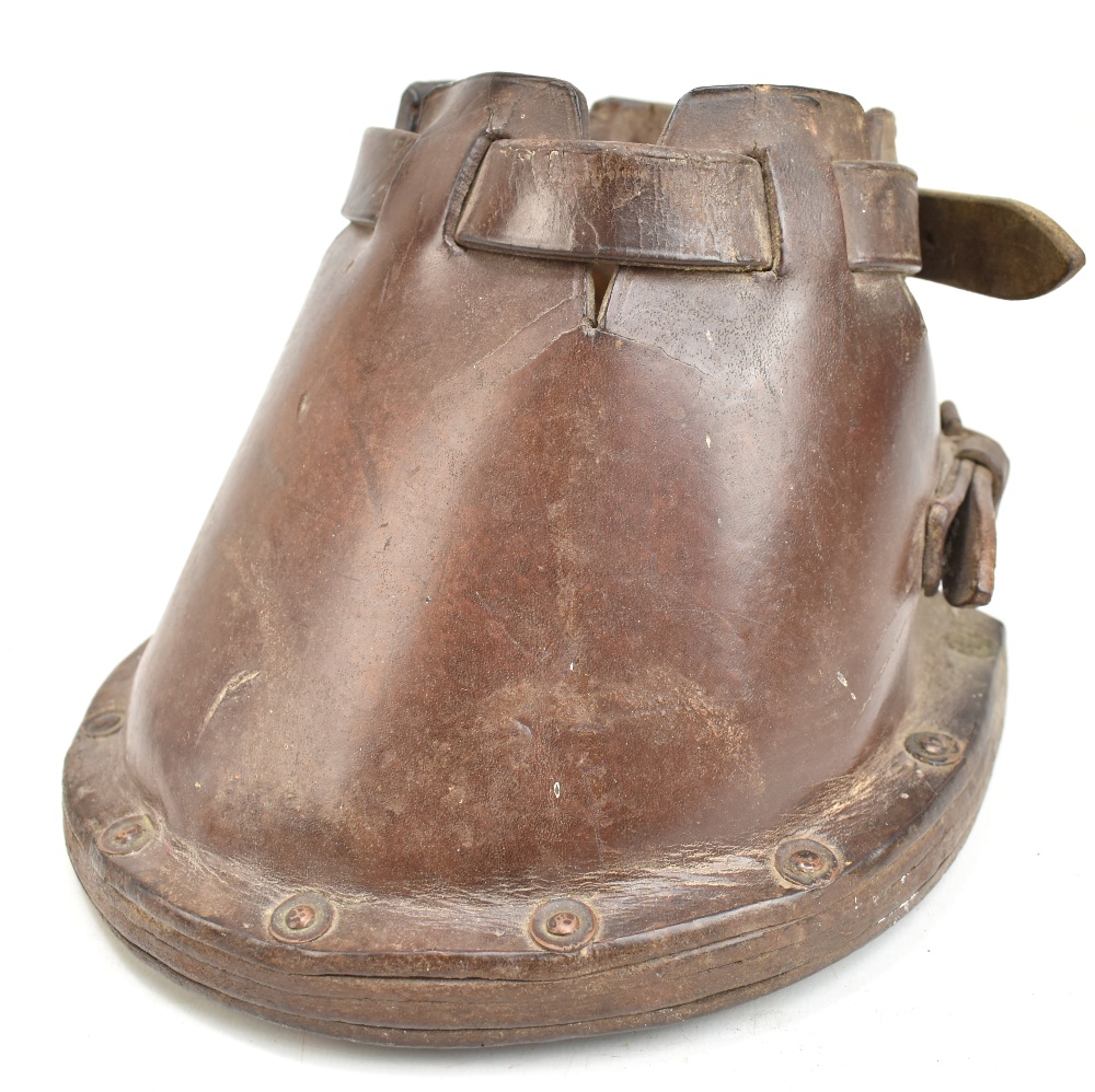 A 19th century horse's leather shoe cover used when mowing cricket pitches, 16 x 20cm.Additional
